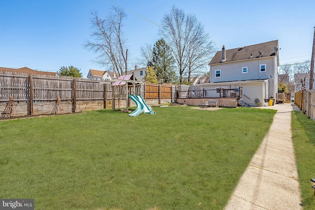 view of yard featuring a playground and a wooden deck