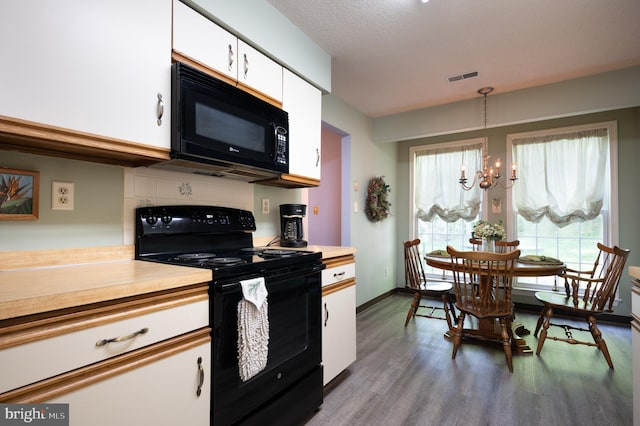 kitchen featuring black appliances, a chandelier, white cabinets, and light countertops
