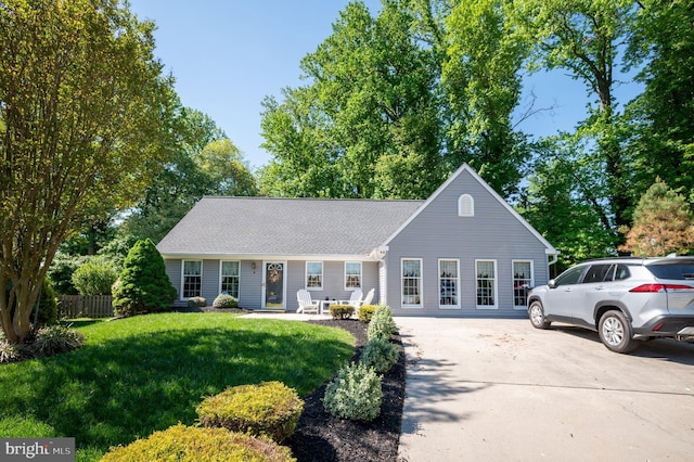 view of front facade featuring driveway and roof with shingles