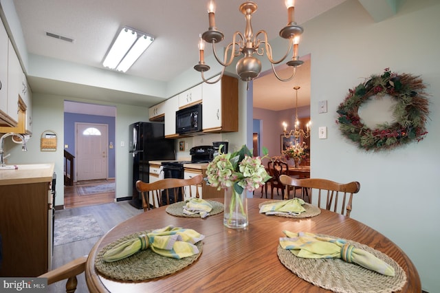 dining space featuring a chandelier and wood finished floors