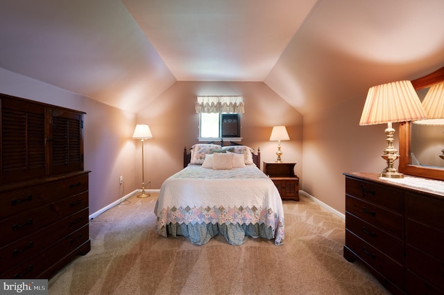 bedroom with carpet floors, lofted ceiling, and baseboards