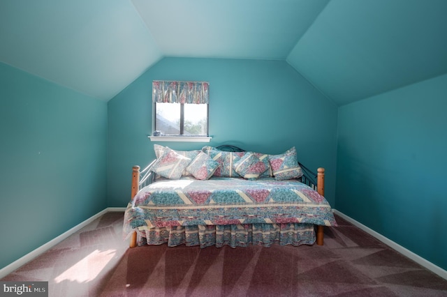 carpeted bedroom featuring vaulted ceiling and baseboards