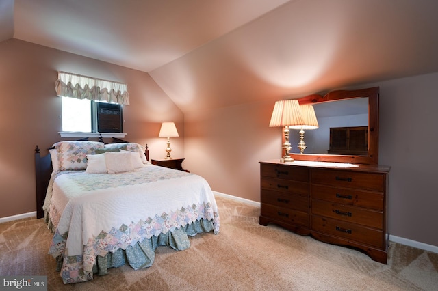 bedroom featuring vaulted ceiling, light colored carpet, and baseboards