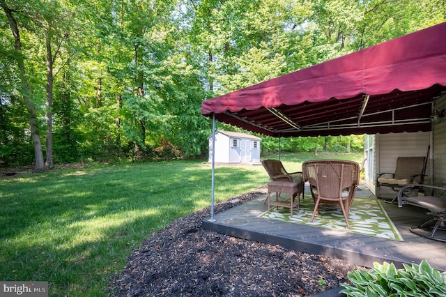 view of grassy yard with a storage shed, a deck, and an outdoor structure