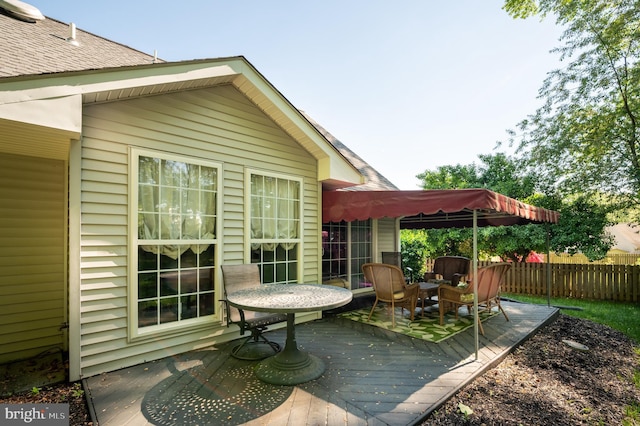 view of patio / terrace with a deck and fence