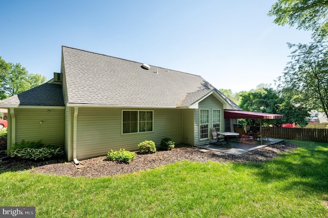 back of property featuring a patio and roof with shingles
