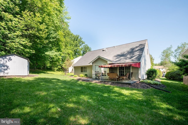 back of house featuring a lawn, an outbuilding, a storage shed, and a patio area