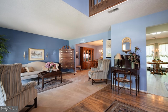 living area with a chandelier and wood finished floors