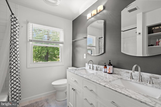 2112 Wittington Blvd, Alexandria, VA 22308 - full bath with toilet, baseboards, double vanity, and a shower with shower curtain