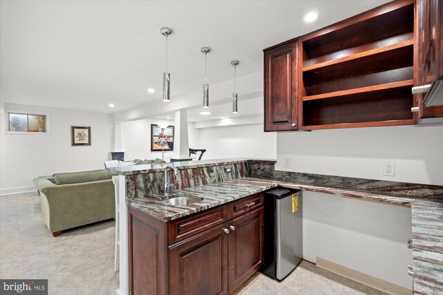 2112 Wittington Blvd, Alexandria, VA 22308 - kitchen featuring a sink, a peninsula, freestanding refrigerator, dark stone counters, and open floor plan