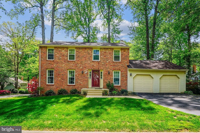 5938 New England Woods Dr, Burke, VA 22015 - colonial home featuring asphalt driveway, a garage, a front lawn, and brick siding