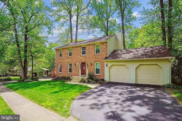 5938 New England Woods Dr, Burke, VA 22015 - colonial home featuring asphalt driveway, a garage, brick siding, a chimney, and a front yard