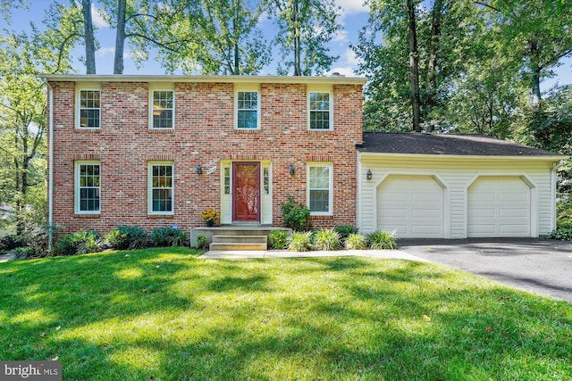 5938 New England Woods Dr, Burke, VA 22015 - colonial home featuring a garage, driveway, a front lawn, and brick siding