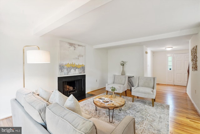 5938 New England Woods Dr, Burke, VA 22015 - living area with a fireplace with flush hearth, light wood-style floors, and beamed ceiling
