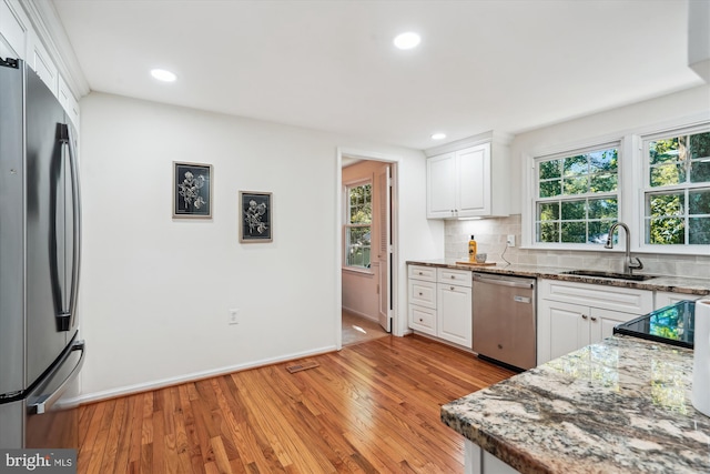 5938 New England Woods Dr, Burke, VA 22015 - kitchen with appliances with stainless steel finishes, white cabinets, light wood-style floors, and recessed lighting