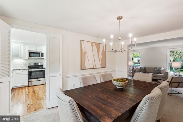 5938 New England Woods Dr, Burke, VA 22015 - dining room featuring a chandelier and light wood-style flooring
