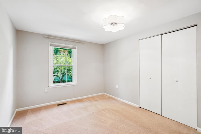 5938 New England Woods Dr, Burke, VA 22015 - unfurnished bedroom featuring light colored carpet and a closet