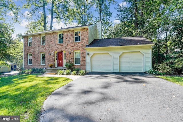 5938 New England Woods Dr, Burke, VA 22015 - colonial home with a garage, driveway, a front yard, a chimney, and brick siding
