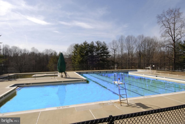 5938 New England Woods Dr, Burke, VA 22015 - community pool with view of scattered trees and a patio area