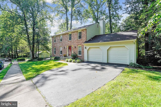 5938 New England Woods Dr, Burke, VA 22015 - colonial-style house with asphalt driveway, a garage, a chimney, brick siding, and a front lawn