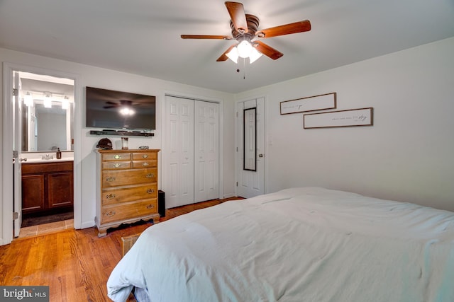 436 Strobridge Rd, Inwood, WV 25428 - bedroom with light wood-type flooring, a closet, ensuite bath, a ceiling fan, and a sink
