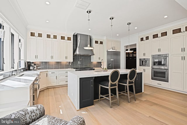 1564 Forest Villa Ln, Mclean, VA 22101 - kitchen featuring wall chimney range hood, stainless steel appliances, a sink, a center island with sink, and backsplash