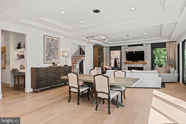 1564 Forest Villa Ln, Mclean, VA 22101 - dining space with a tray ceiling, light wood-style flooring, a fireplace, stairway, and recessed lighting