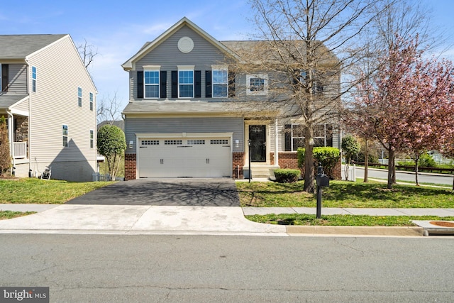 100 Fiesta Dr, Stephenson, VA 22656 - view of front facade with brick siding, an attached garage, and driveway