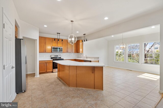 100 Fiesta Dr, Stephenson, VA 22656 - kitchen featuring stainless steel appliances, a chandelier, light countertops, plenty of natural light, and recessed lighting