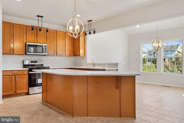 100 Fiesta Dr, Stephenson, VA 22656 - kitchen with stainless steel appliances, a chandelier, light countertops, and recessed lighting