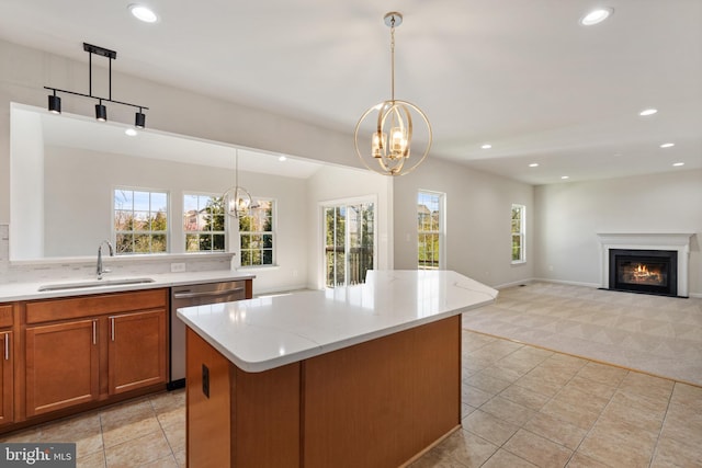 100 Fiesta Dr, Stephenson, VA 22656 - kitchen with a sink, a chandelier, dishwasher, light colored carpet, and brown cabinetry