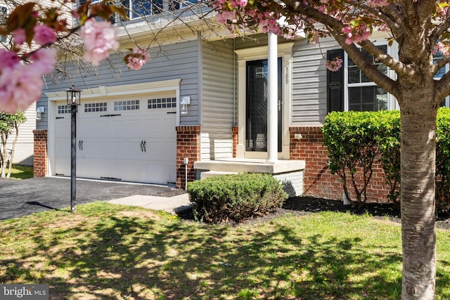 100 Fiesta Dr, Stephenson, VA 22656 - view of front of property with brick siding, driveway, an attached garage, and a front lawn