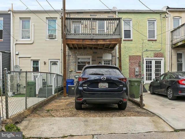 220 S E Ave, Baltimore, MD 21224 - view of front of house with a balcony, french doors, cooling unit, and stone siding