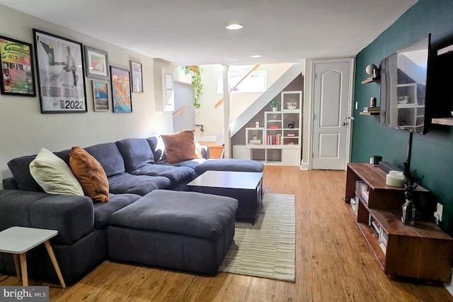 living area featuring stairs, wood finished floors, and recessed lighting