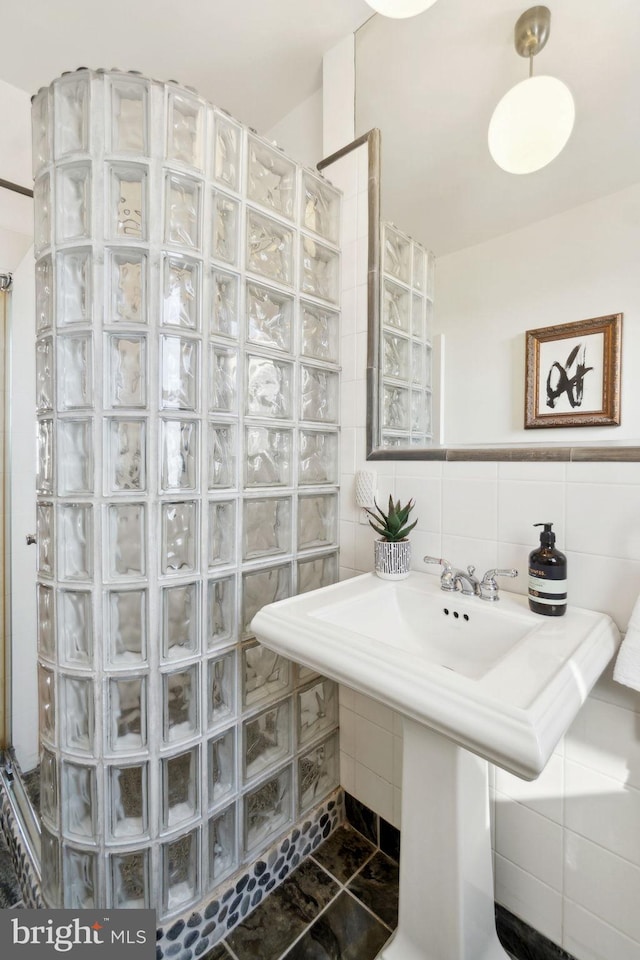 1901 Columbia Rd NW Unit 805, Washington, DC 20009 - full bathroom with a walk in shower, tile walls, backsplash, and tile patterned floors