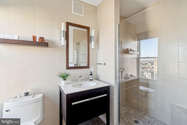 1901 Columbia Rd NW Unit 805, Washington, DC 20009 - bathroom with tile walls, a shower stall, vanity, and toilet