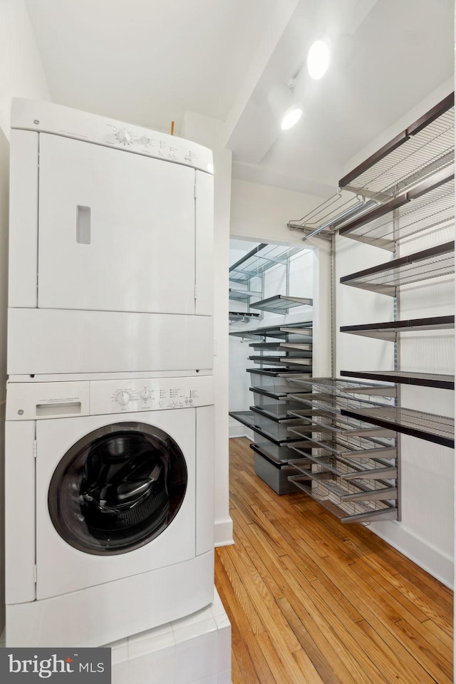 1901 Columbia Rd NW Unit 805, Washington, DC 20009 - laundry area featuring stacked washing machine and dryer and light wood-style flooring