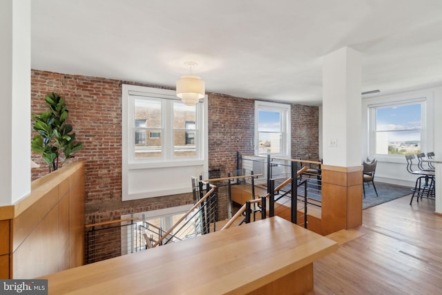 1901 Columbia Rd NW Unit 805, Washington, DC 20009 - dining area featuring healthy amount of natural light, wood finished floors, and brick wall