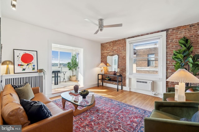 1901 Columbia Rd NW Unit 805, Washington, DC 20009 - living room with healthy amount of natural light, wood finished floors, a wall mounted AC, a ceiling fan, and brick wall