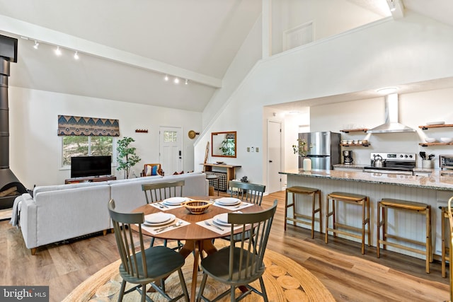 114 Limestone Ln, Berkeley Springs, WV 25411 - dining room with track lighting, light wood-type flooring, high vaulted ceiling, and beamed ceiling
