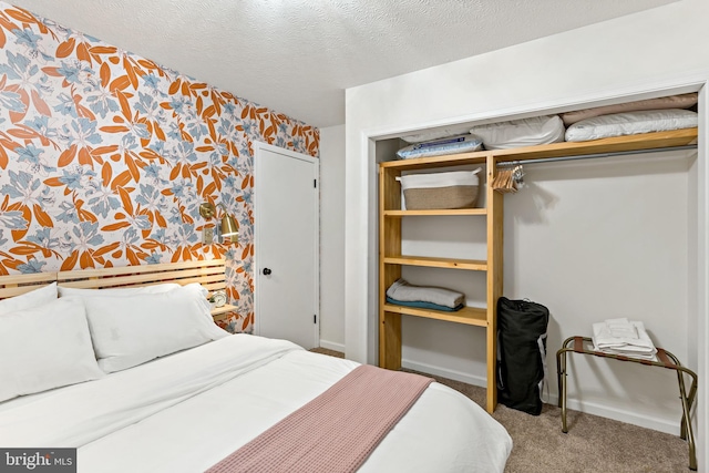 114 Limestone Ln, Berkeley Springs, WV 25411 - carpeted bedroom featuring wallpapered walls, a closet, baseboards, and a textured ceiling