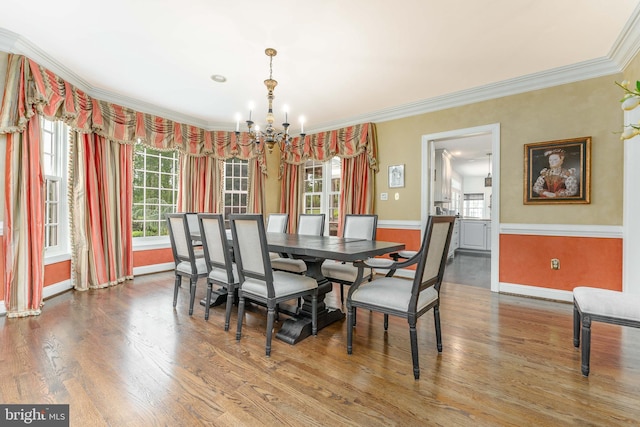 201 Dogwood Slope Rd, Wilmington, DE 19807 - dining space with a chandelier, crown molding, wood finished floors, and a wainscoted wall