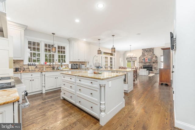 201 Dogwood Slope Rd, Wilmington, DE 19807 - kitchen with a center island, white cabinetry, tasteful backsplash, open floor plan, and dark wood finished floors