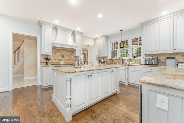 201 Dogwood Slope Rd, Wilmington, DE 19807 - kitchen with premium range hood, white cabinets, tasteful backsplash, and recessed lighting