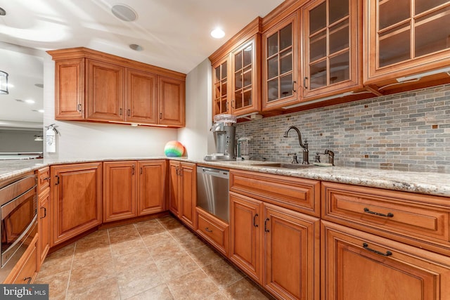 201 Dogwood Slope Rd, Wilmington, DE 19807 - kitchen with stainless steel appliances, brown cabinetry, decorative backsplash, light stone countertops, and recessed lighting