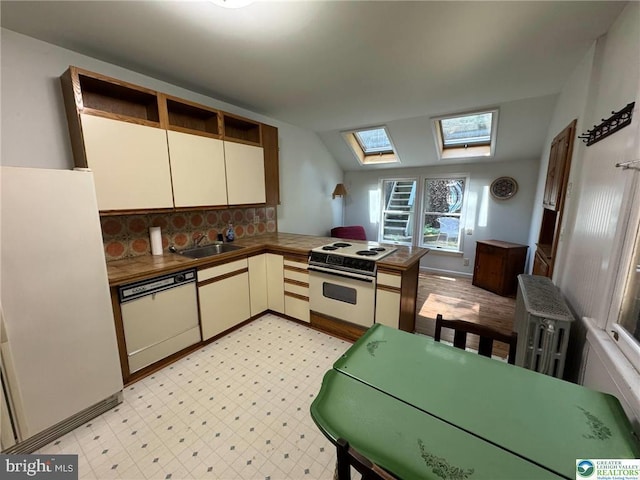 35 W Broadway, Jim Thorpe, PA 18229 - kitchen featuring white appliances, a skylight, a sink, backsplash, and radiator heating unit