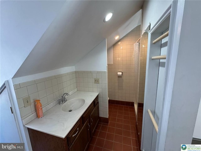 35 W Broadway, Jim Thorpe, PA 18229 - full bath with tile walls, vaulted ceiling, tile patterned floors, vanity, and a shower with curtain