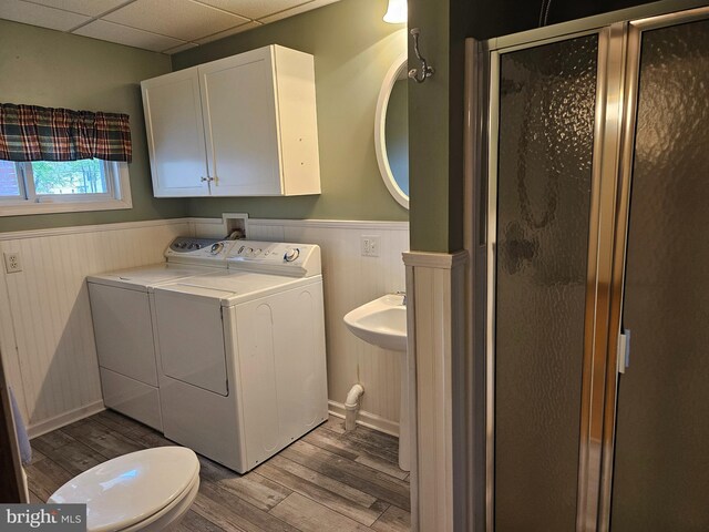 304 Pulaski St, Cumberland, MD 21502 - full bathroom with independent washer and dryer, a wainscoted wall, wood finished floors, a stall shower, and a drop ceiling