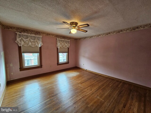304 Pulaski St, Cumberland, MD 21502 - empty room featuring hardwood / wood-style floors, a textured ceiling, ceiling fan, and baseboards