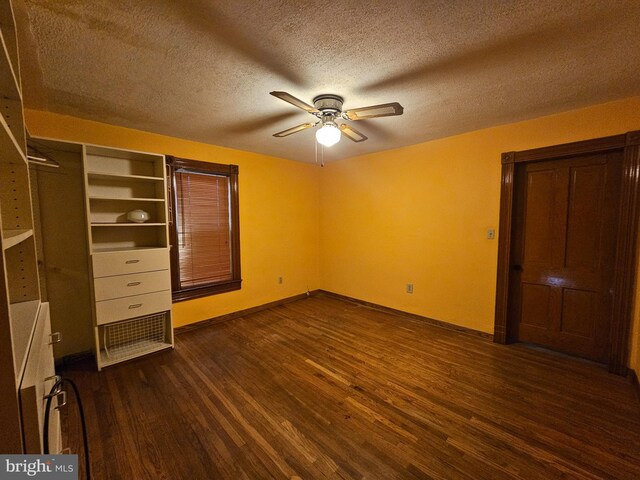304 Pulaski St, Cumberland, MD 21502 - unfurnished bedroom featuring dark wood finished floors, a textured ceiling, baseboards, and a ceiling fan